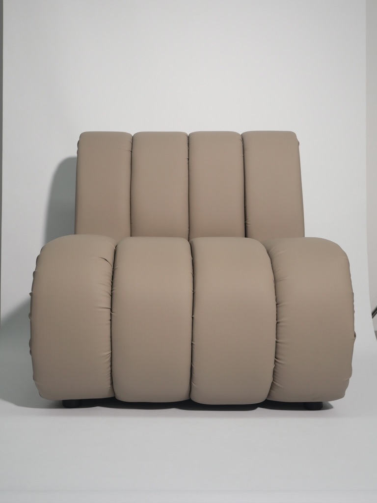 Sand-coloured bubble chair, oversized and softly contoured.