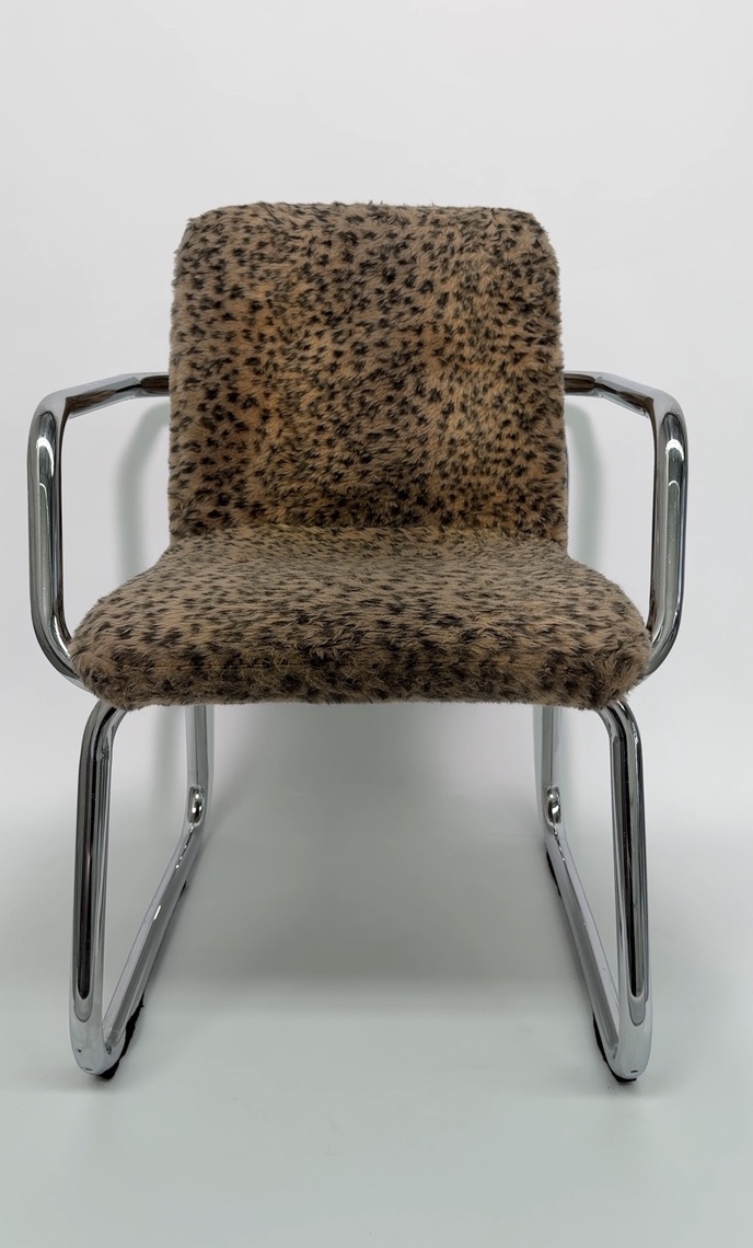 Chrome-framed mid-century chair upholstered in cheetah print bouclé.