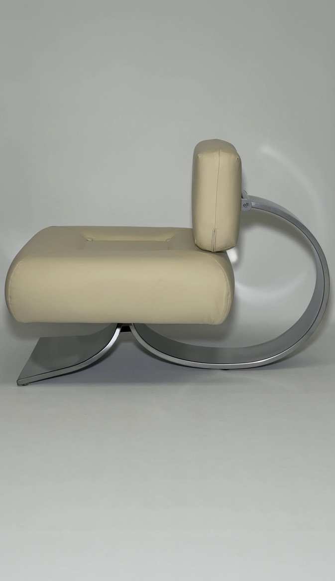 Side view of the butter yellow chair, showing chrome curve.